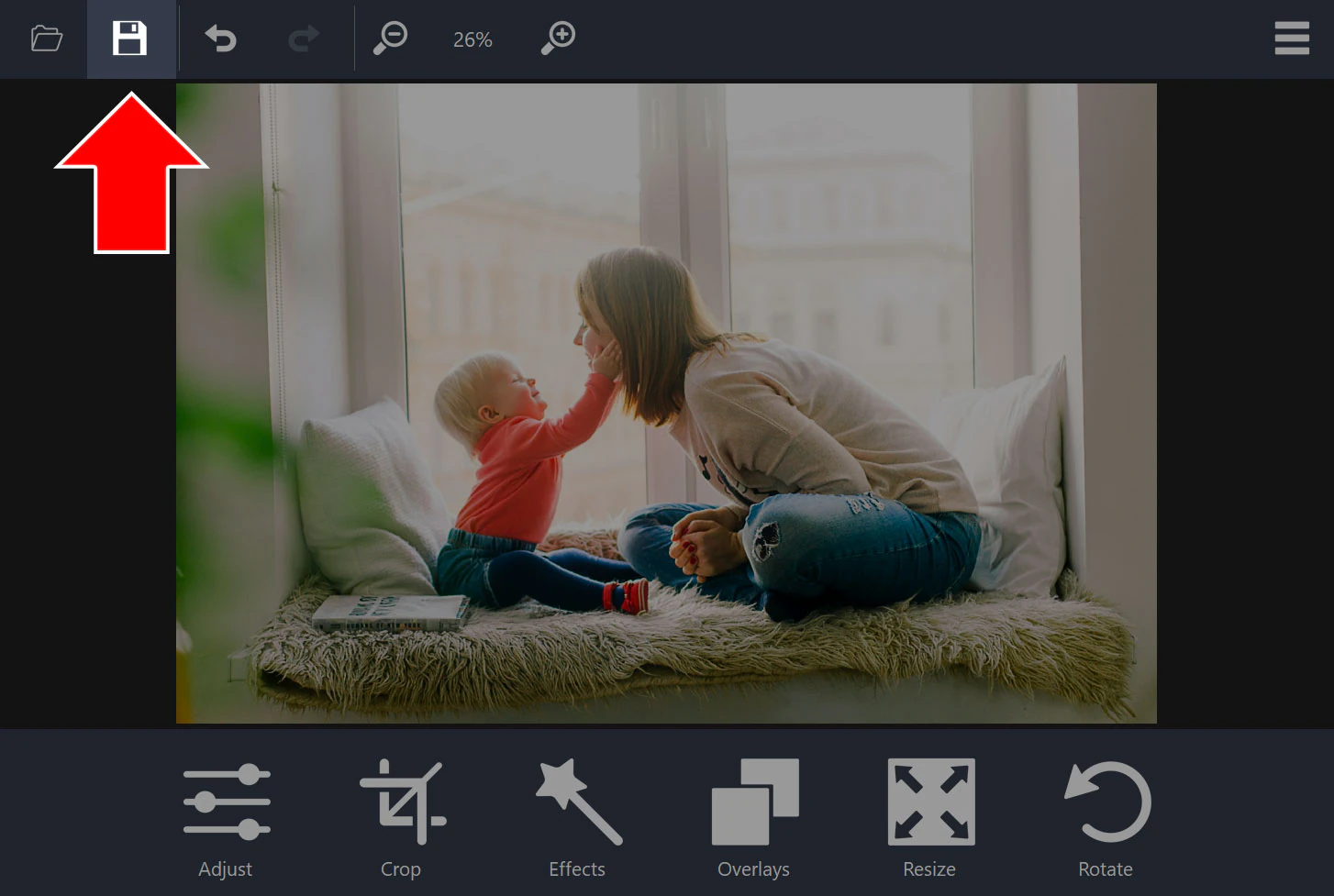 Cropped photo in the editor with an arrow pointing to the disk icon in the toolbar
